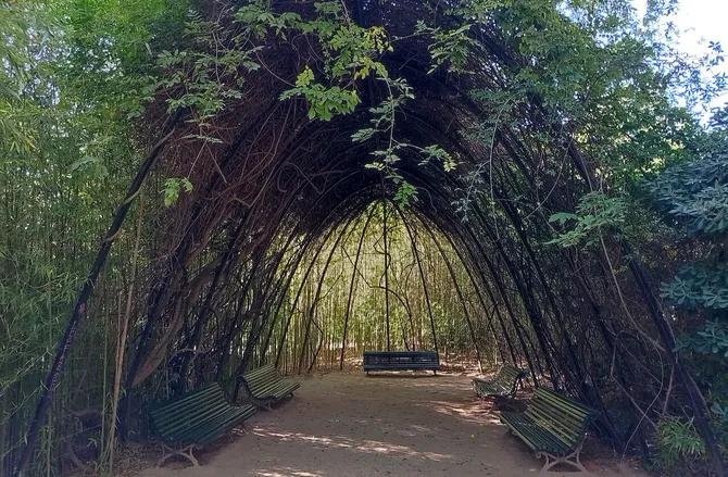 Shaded seating area under an archway in Pedralbes Park in Barcelona